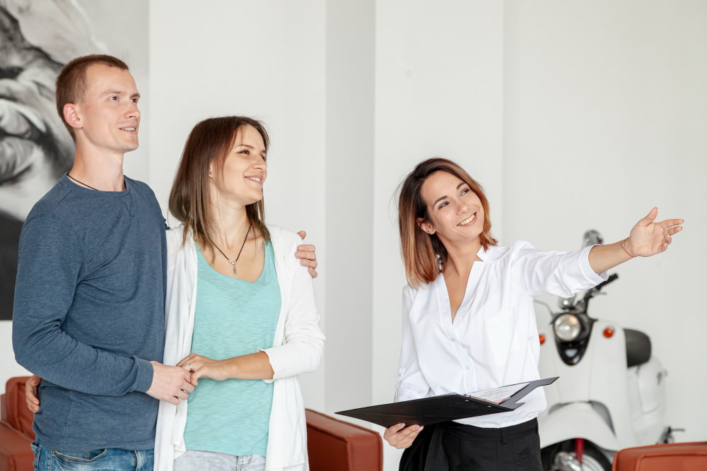 A realtor shows a house to a married couple.