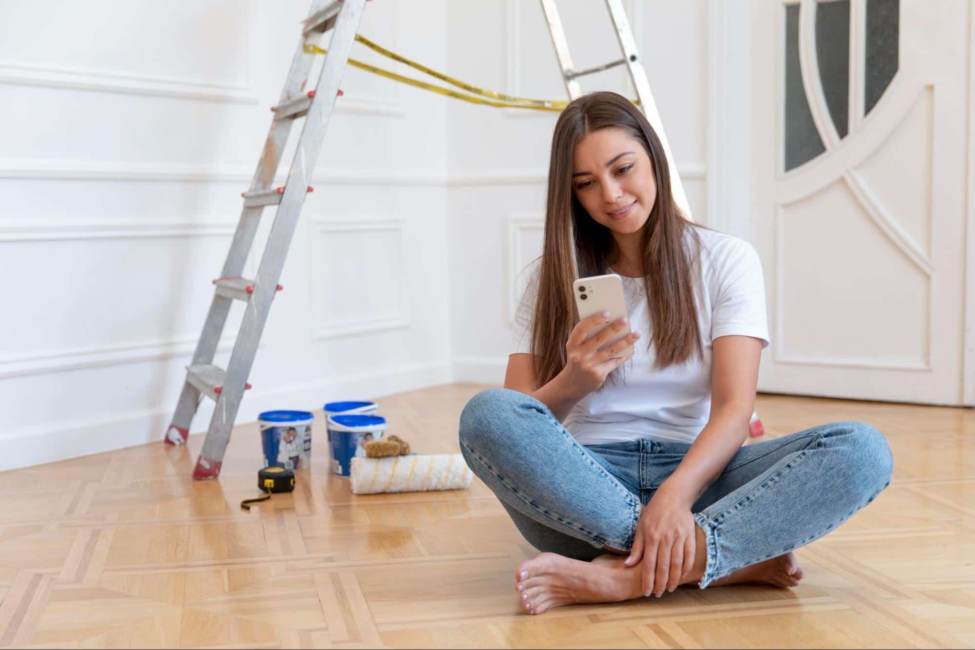 A woman is sitting on the floor at home.